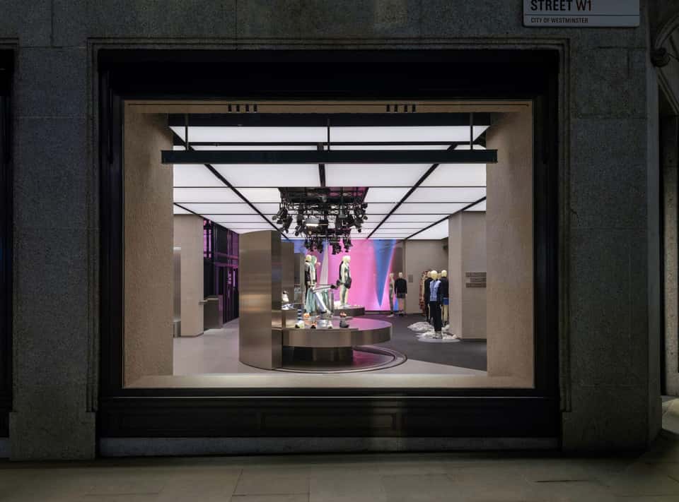 View of the On Running store interior with brightly lit LED wall in the back.