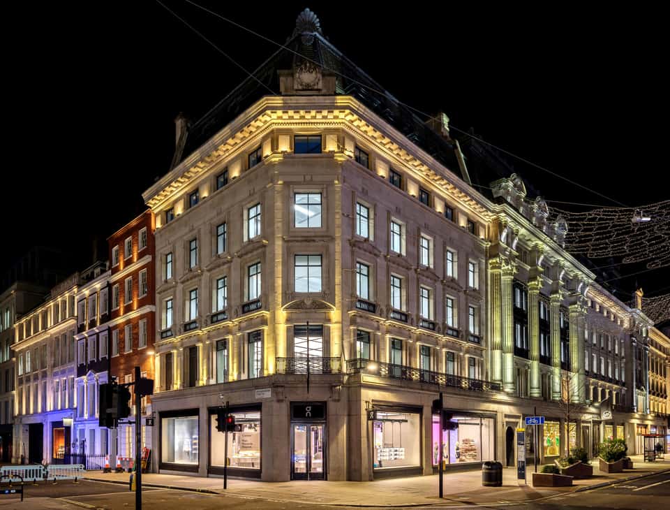 On store in a big historical building with large glass windows and the LED wall visible from the outside.