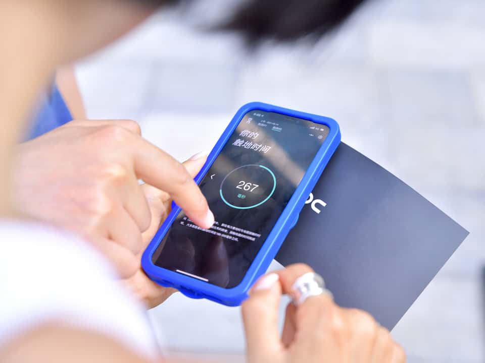 Store personnel and customer interacting with the On Running installation in a store.