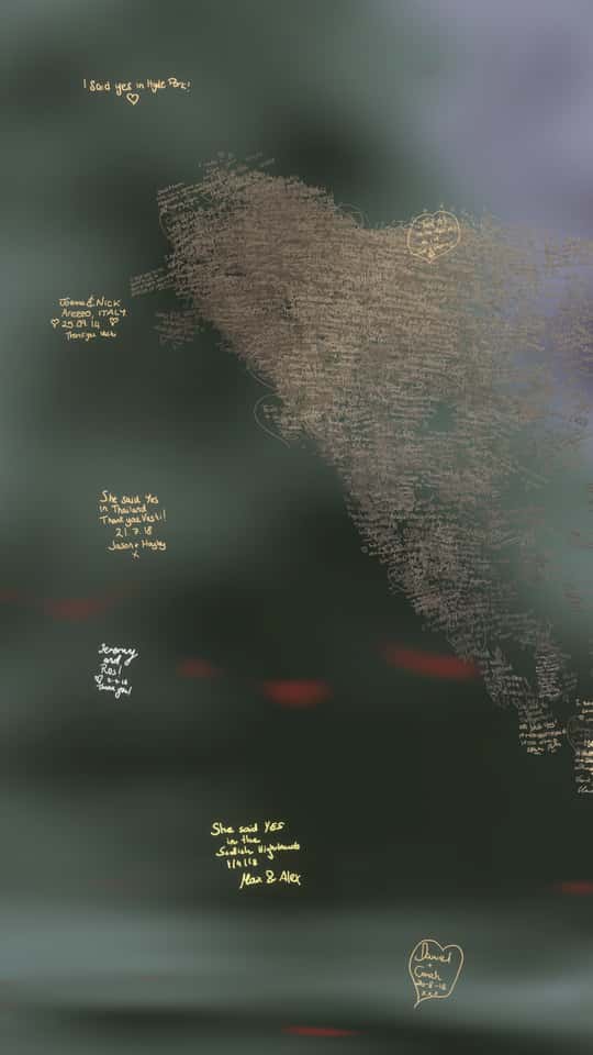 Still of the VASHI Love Wall installation showing a colorful cloud of animated particles forming hand-drawn shapes and messages.