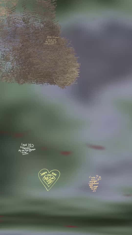 Still of the VASHI Love Wall installation showing a colorful cloud of animated particles forming hand-drawn shapes and messages.